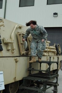 (Photo by Hannah Davis) Destinee Barrett climbs down from a tank.