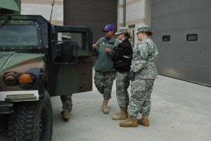 (Photo by Hannah Davis) WOC Ingrid Keller, second from the left, speaks to Samantha Hurdle, second from the right, and Jennifer Joyner, right, as their fellow JROTC member gets in the truck.