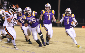 Photo by Titus Mohler Central High School junior Keenan Anunay, far right, looks for a running lane with the football as senior Kester Long, No. 67, senior Chris Fowler, No. 45, and sophomore Jackson Dalton, No. 7, look for blocking opportunities.
