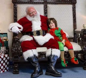 Photo by Shutterbatte Photography Santa and his elf, Gavin Kerr, at the Victoria Public Library during the town’s Small Town Christmas celebration.